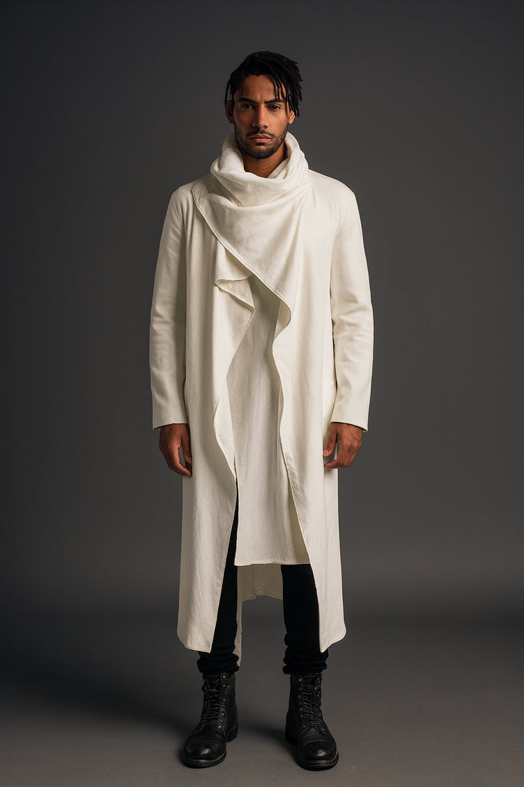 Man wearing a long white coat with a high collar against a gray background