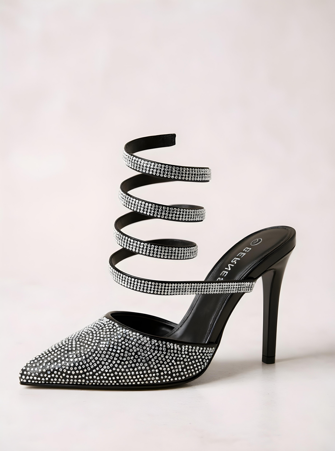 Black high-heeled shoe with rhinestone embellishments on a light gray background