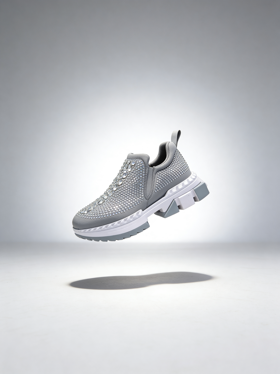 Gray rhinestone womens sneaker on a light gray background