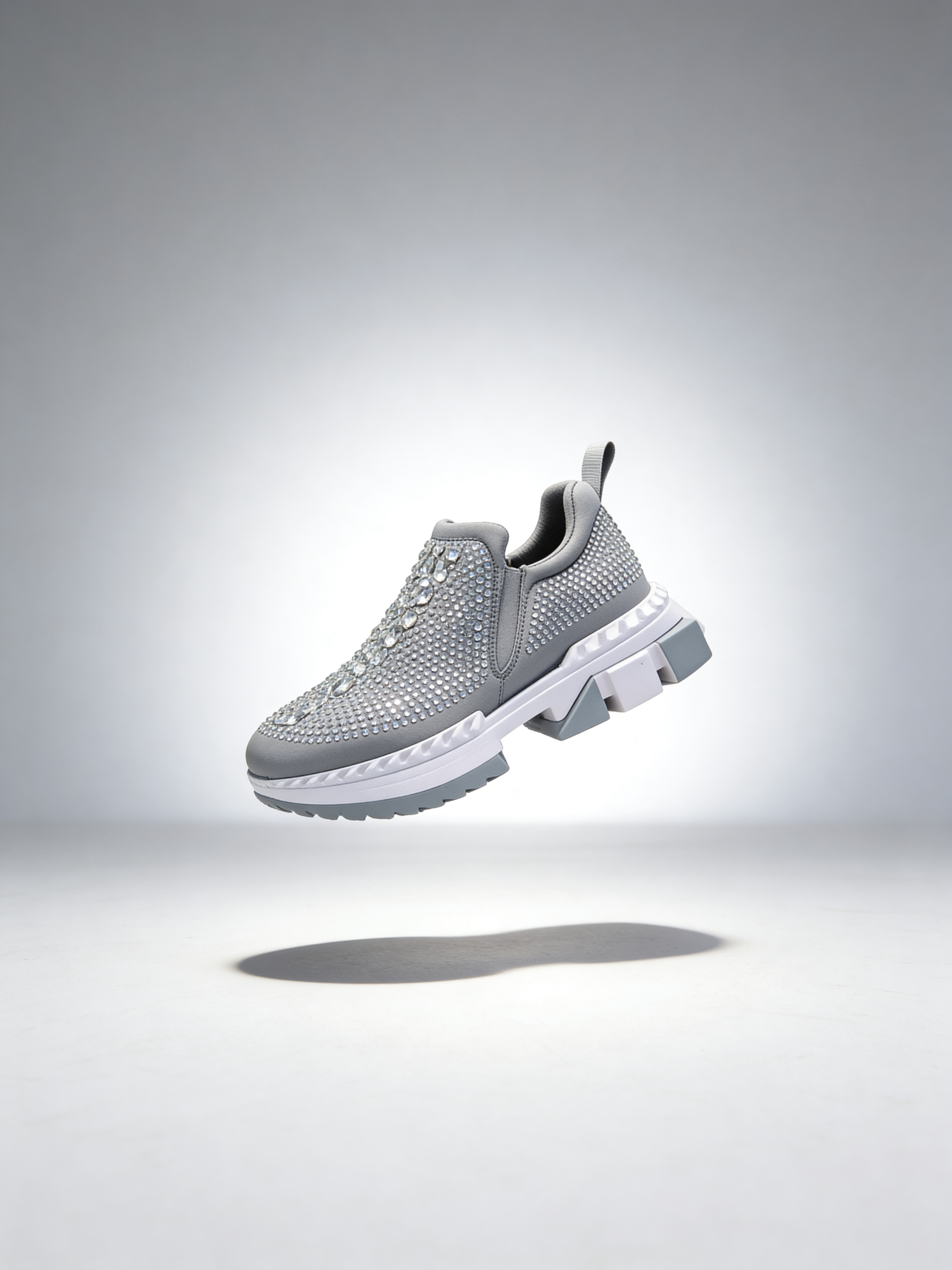 Gray rhinestone womens sneaker on a light gray background
