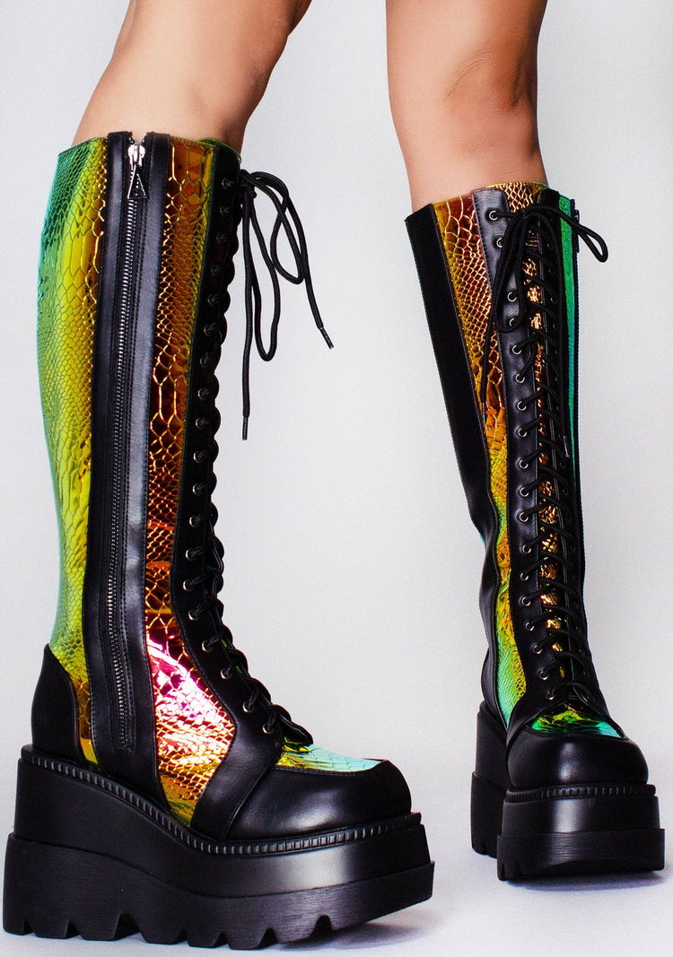 Colorful platform boots with snake print on a white background