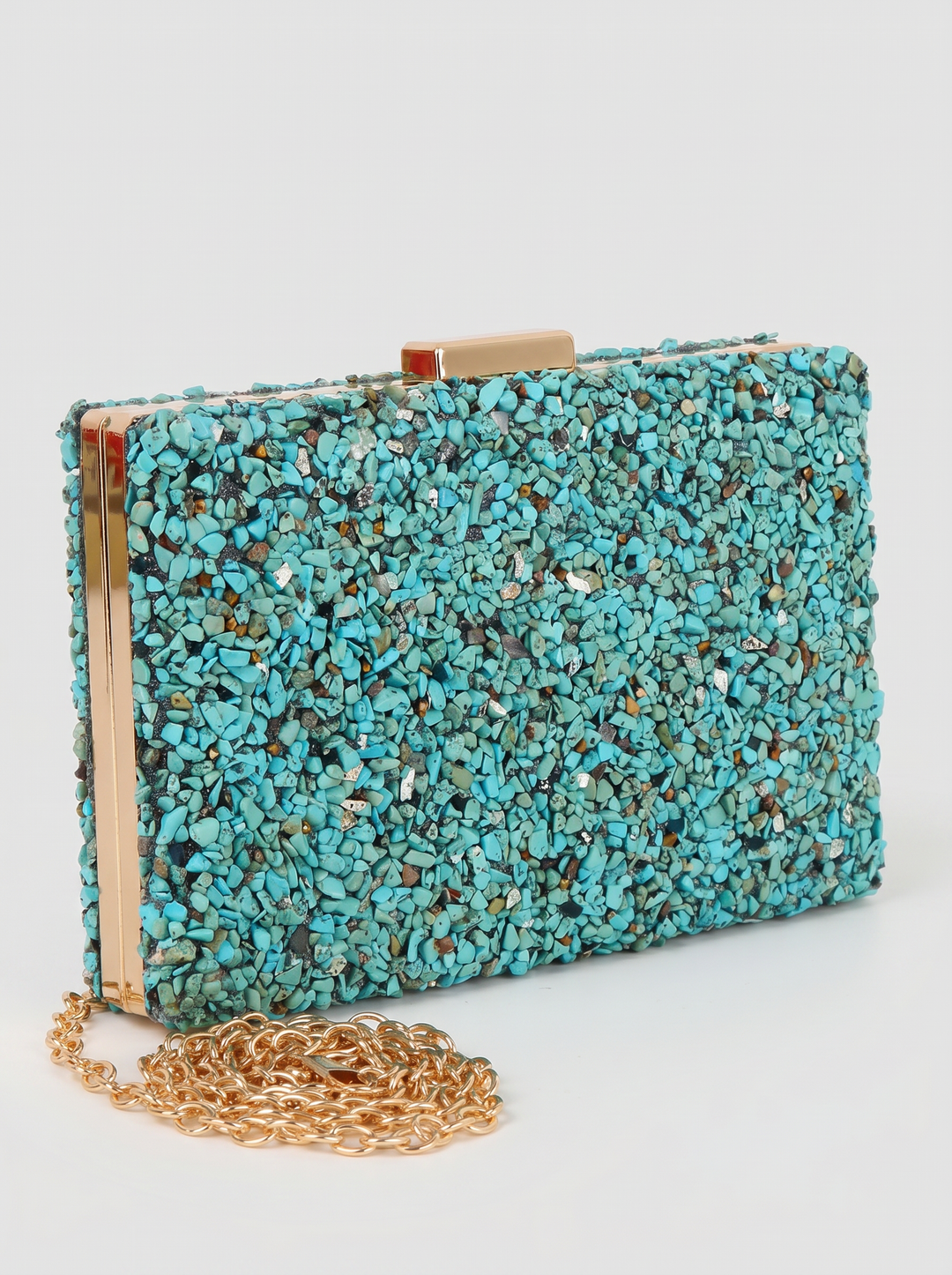 Turquoise textured clutch bag with gold chain on a white background