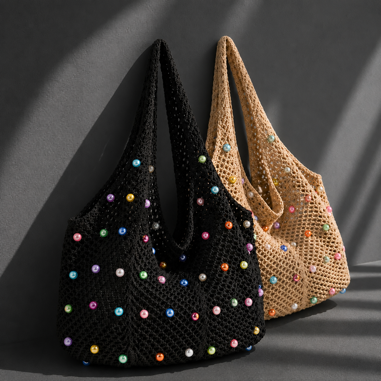 Two crochet bags, one black and one beige, with colorful beads on a dark background