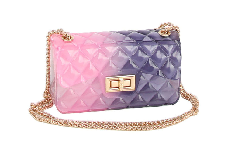 Gradient pink to purple handbag with gold chain on a white background